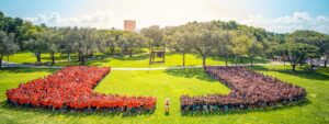 Large group of people creating the U of U Miami